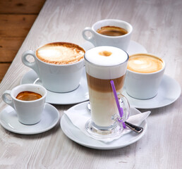 set of coffee drinks on the white wooden background