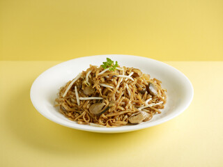 stewed ee-mian noodles with Dried Shrimps served in a dish isolated on cutting board side view on dark background