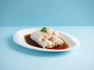 Steamed Rice Rolls with Fresh Prawn Filling with chopsticks served in a dish isolated on mat side view on grey background
