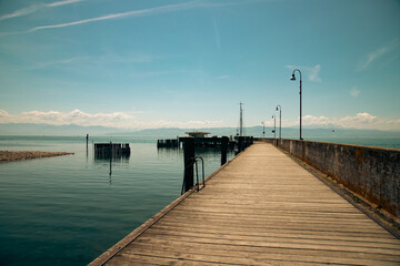 Fototapeta na wymiar Landing stage for motor and sailing boats in the little port of Langenargen, Lake Constance.