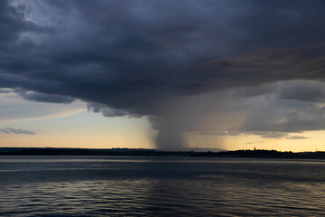 Naklejka na ściany i meble Heavy dark fast moving thunderstorm clouds over lake Constance, Germany