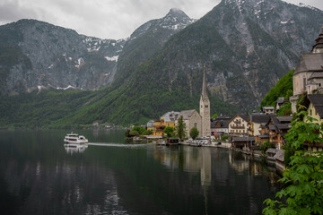 Beautiful view of Hallstatt, Austria, picturesque village on the edge of a lake. Classical view with one of the ships just departing.