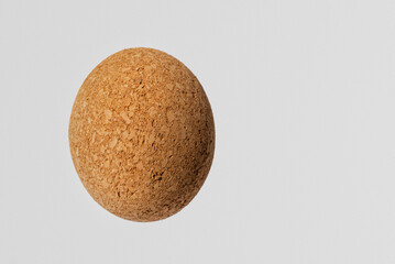 Nice brown egg oval shape cork on the white gray background.Copy space.