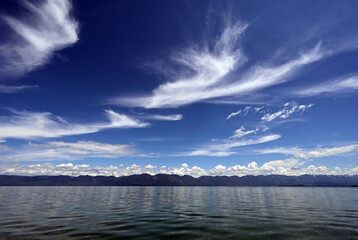 Beautiful dramatic summer cloudscape over Flathead Lake in Montana on calm June day.