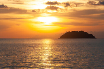 Fototapeta premium Colorful beach sunset view with island background. Copy space