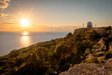 Fototapeta na wymiar Sunset over Dingli Cliffs, Malta. Radar visible in the background. Photo taken in January 2022.