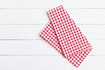 Fabric red and white tablecloth checkered on white the wood background. Top view, Flat lay cotton...