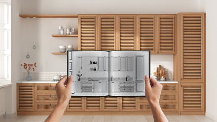 Hands holding notepad with cozy wooden kitchen design blueprint sketch or drawing. Real interior design project background. Before and after concept, architect designer work flow idea