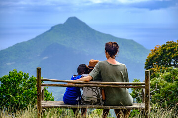 Family on a bench on top of Black River Gorge trail, Mauritius