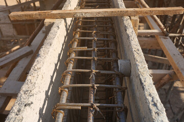 Reinforced steel beams with single concrete spacers round type in plastic formwork for pouring...