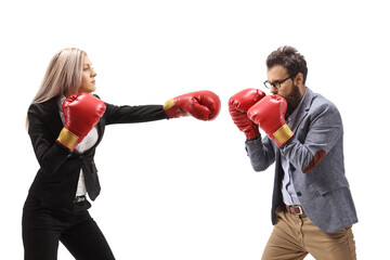 Profile shot of a man and woman in formal clothes fighting with boxing gloves