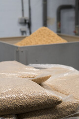 Pallets of Heating pellets in plastic bags. Fuels from coniferous shavings.