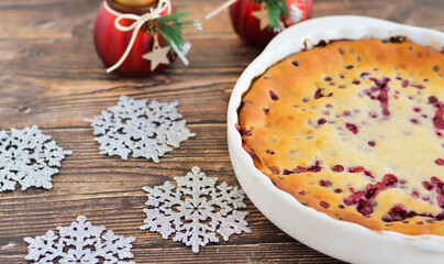 Traditional homemade Christmas cake on a white plate festive dessert with cranberries on the background of Christmas decorations