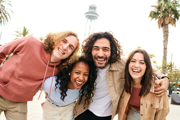 Selfie of a group of friends looking at the camera and smiling. Multiracial people taking selfie