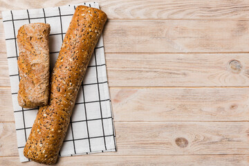 fresh crunchy french baguette on colored table. Top view Bakery products