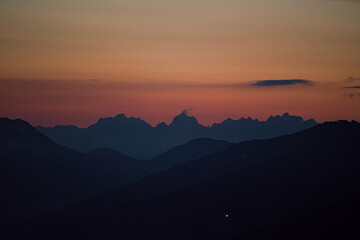 beautiful view of the wilder kaiser in tirol austria at the sunset with red sky - obrazy, fototapety, plakaty