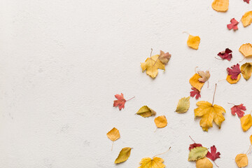 Autumn composition. Pattern made of dried leaves and other design accessories on table. Flat lay, top view