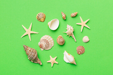 Summer time concept Flat lay composition with beautiful starfish and sea shells on colored table, top view