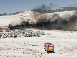 Fire in a tire dump. Heavy black smoke from burning old tires