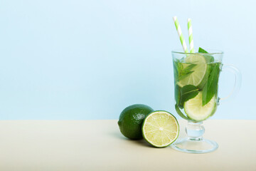Mojito summer refreshing cocktail with ice and mint. mojito cocktail with lime, lemon and mint in a tall glass with a stick