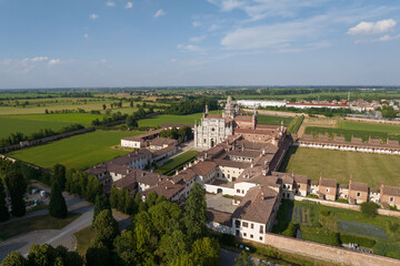 Fototapeta na wymiar Aerial view of the Certosa di Pavia at sunny day, built in the late fourteenth century, courts and the cloister of the monastery and shrine in the province of Pavia, Lombardia, Italy