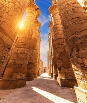 Columns with ancient carvings in the Great Hypostyle Hall of Luxor, Karnak Temple, Egypt