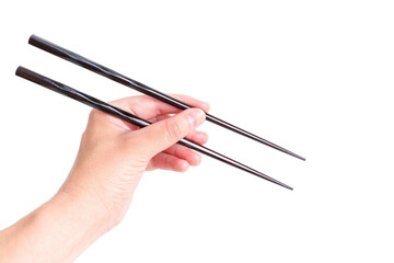 Wooden chopsticks in hand against white background