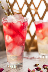 Refreshing summer pink drink, lemonade. Rose cocktail. Ovshala drink. vertical position.