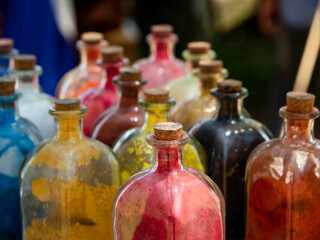 glass bottles with cork stopper with powder colors inside