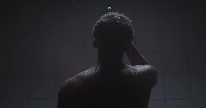 Young black athlete taking a warm shower.