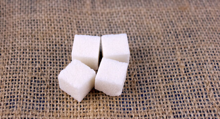 Sugar cubes on brown wicker background