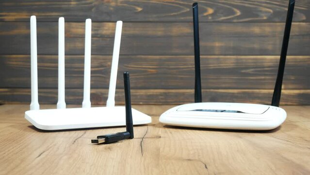 Man choose of different types of Wi-Fi routers, modern and old technology. Wireless ethernet connection signal. USB Wifi Receiver Wireless Network Card. High Speed Antenna Wifi Adapters.