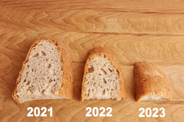 Three pieces of bread larger, smaller and even smaller on a wooden board. The concept of the food...