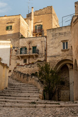 Fototapeta na wymiar Abandoned alley with staircase in the historic downtown of Matera, Southern Italy