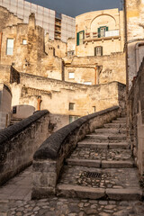 Fototapeta na wymiar Abandoned alley with staircase in the historic downtown of Matera, Southern Italy