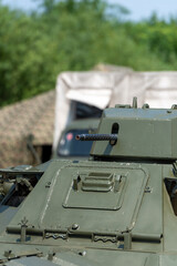 part of a photo of an armored car standing in the meadow behind other military vehicles