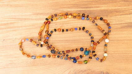 colorful bead necklace made of wood on wooden table