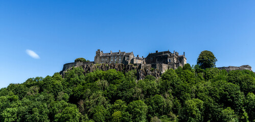 Fototapeta na wymiar view of the Stirling Castle and Castle Hill with green summer forest under a blue sky