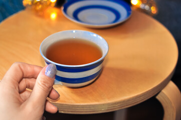 close up of cup of tea with blue stripes at home ,teatime and relax