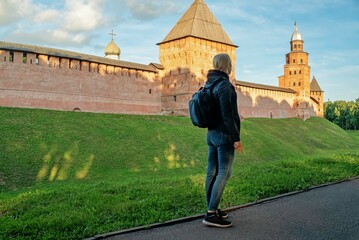 Tourist woman look at the Kremlin wall in Veliky Novgorod