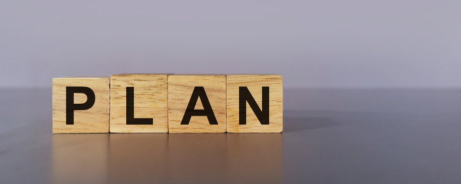 plan on wooden box on gray background,Doing business must have a plan to work towards the goal.