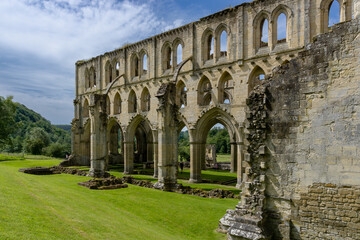 Fototapeta premium view of the nave and church ruins in the historic Rievaulx Abbey in North Yorkshire