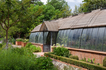 Fototapeta na wymiar Vintage greenhouse in a French park in Spring