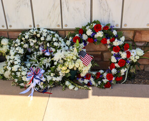 Patriotic wreath flower arrangements at a columbarium in cemetery.
