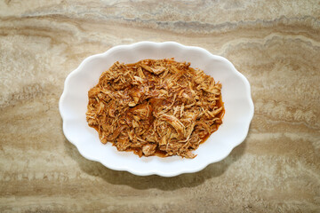 Tinga de pollo or chicken tinga served on a white serving bowl.