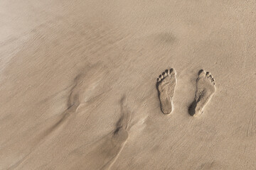 Two footsteps in the sand on a walk in Maui Hawaii