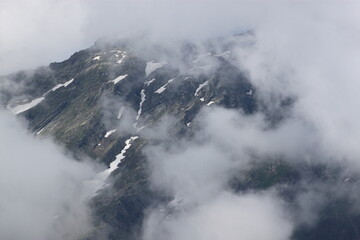 Obraz premium The top of the mountain in the clouds near Lake Ritsa in Abkhazia.