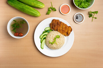 Chicken Cutlet Rice with raw cucumber, Coriander, salad, sauce and soup served in a dish isolated on wooden background top view