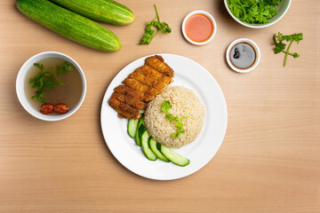 Chicken Cutlet Rice with raw cucumber, Coriander, salad, sauce and soup served in a dish isolated on wooden background top view
