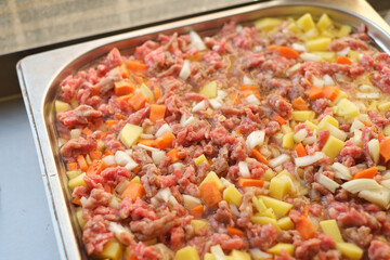 turkish bulgarian moussaka in aluminum profile cooking process raw vegetables and minced meat before baking